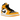 Air Jordan 1 Mid Taxi baskets en vue inclinée avec empeigne en cuir jaune et blanc, logo swoosh noir et lacets noirs classiques