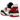 New Balance 550 White Red Black baskets vue latérale avec empeigne en cuir blanc, détails noirs et logo New Balance rouge sur le côté