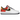 Nike Air Force 1 Low Raygun baskets vue sous angle, montrant l'empeigne en cuir blanc avec des accents noir, orange et jaune et un motif brodé.