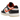 Nike Dunk Low PRM Halloween baskets en vue angulaire avec design en cuir noir et blanc, détails swoosh orange et semelle extérieure assortie