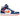 Air Jordan 1 Mid Knicks baskets vue de profil classique avec des détails en cuir bleu roi et orange, une semelle intermédiaire blanche et un swoosh noir.