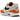 Nike Air Max 1 Monarch baskets vue en angle avec empeigne blanche, détails en cuir orange, unité Air visible et semelle blanche.